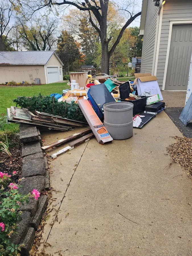 Dumpster being loaded with debris for Demolition Dumpster Rental in Coffeyville